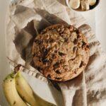 Fresh homemade spiced banana bread accompanied by ripe bananas and slices. Perfect lighting for food photography.